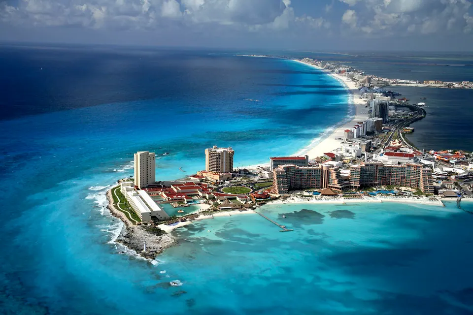 Destination view of Cancún’s Hotel Zone between the Caribbean Sea and lagoon; photograph from 2008, not a photograph of this property or venue